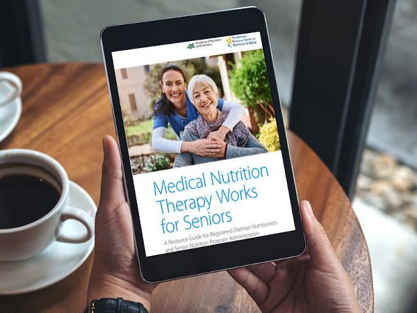 hands holding a tablet with MNT Works for Seniors toolkit on screen