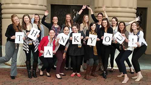 An image of dietetic interns standing in a group with individual letter spelling Thank You.