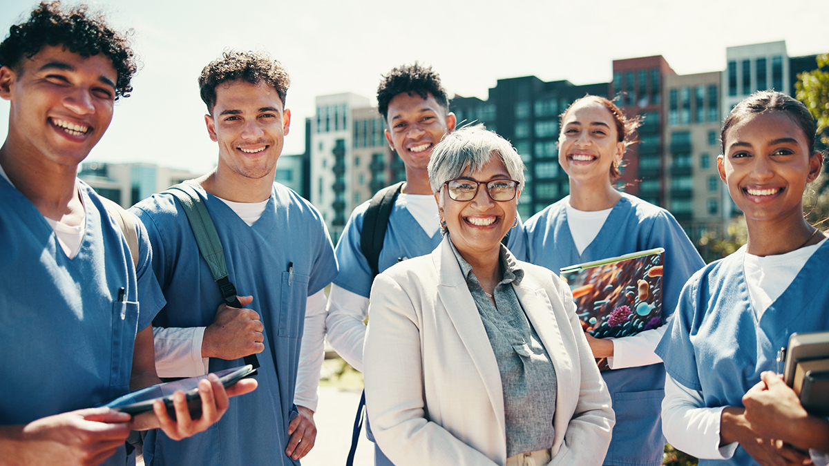 professor standing with medical students