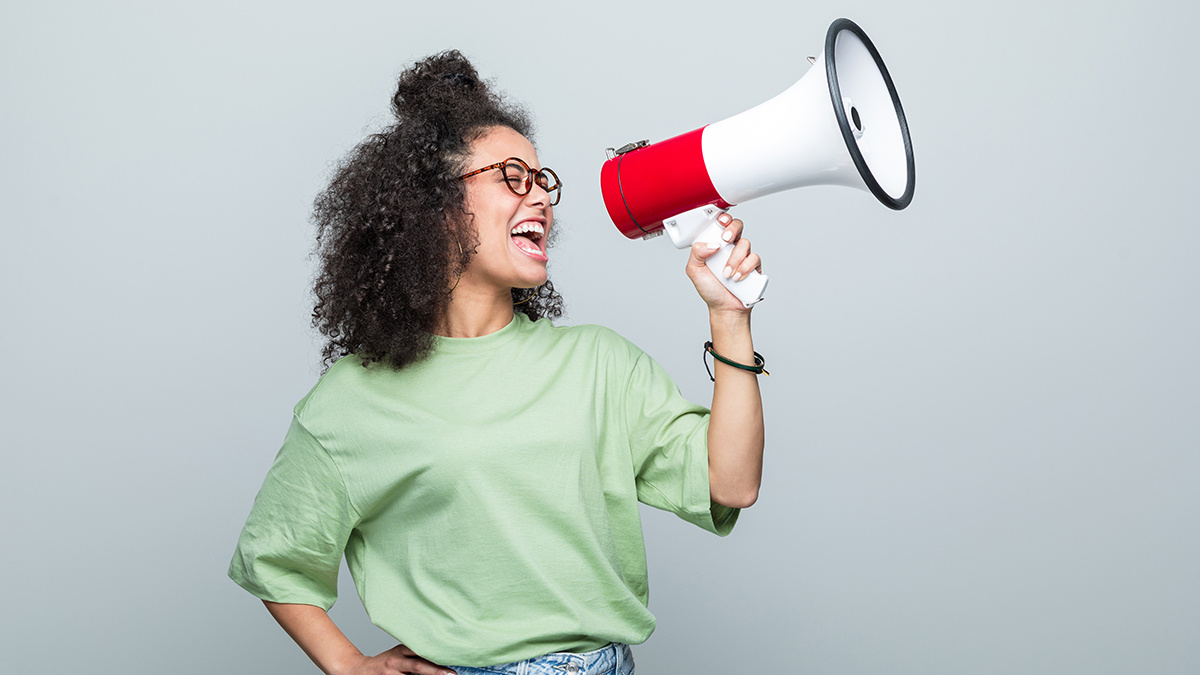 Woman with bullhorn urging people to take action