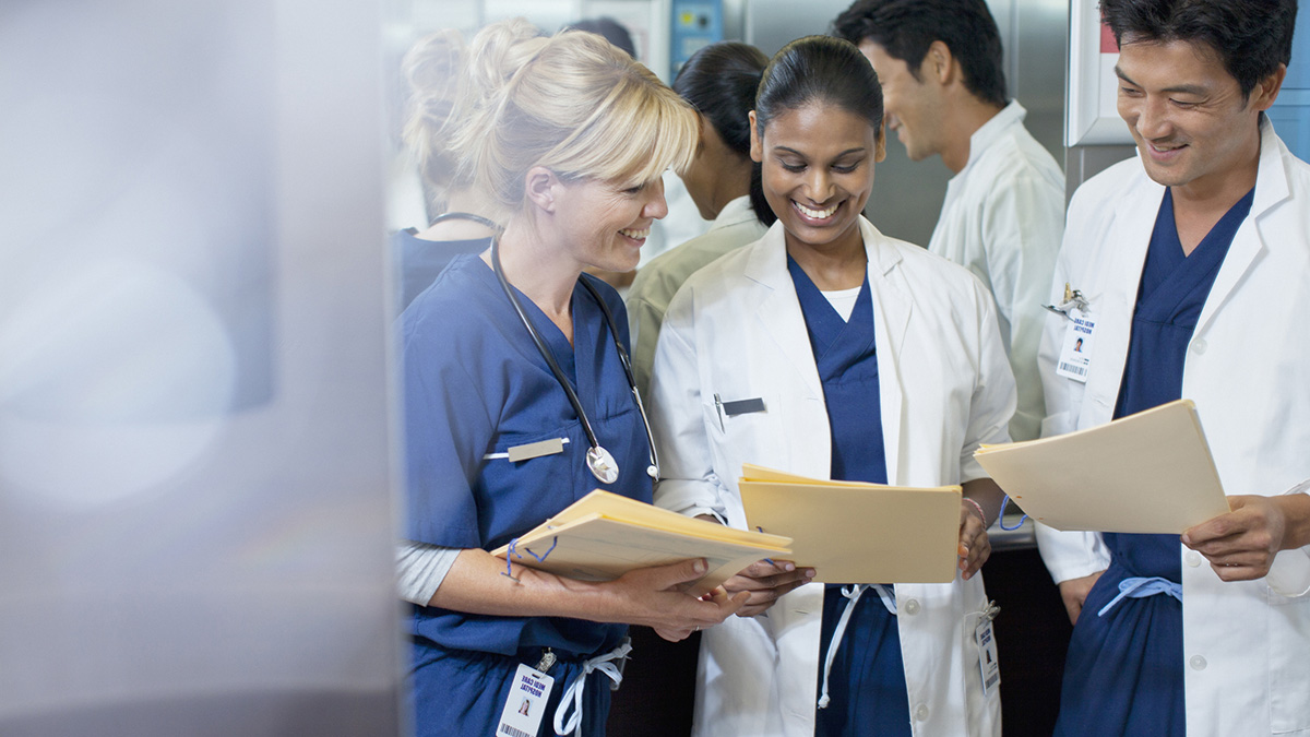Working with RDNs photo of a medical team consulting a patient file