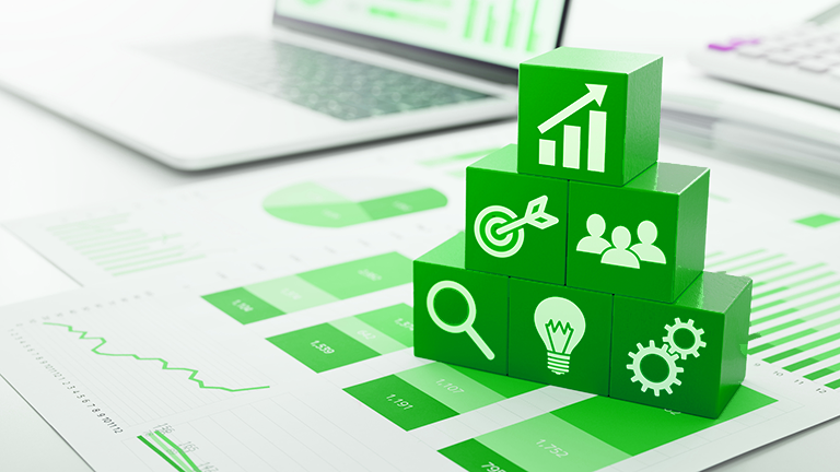 building blocks laying on top of a table with financial reports