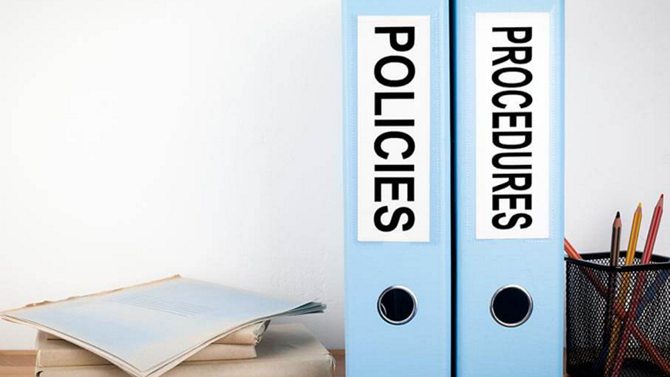 policy binders on a desk