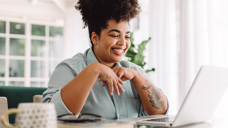 woman at computer smiling