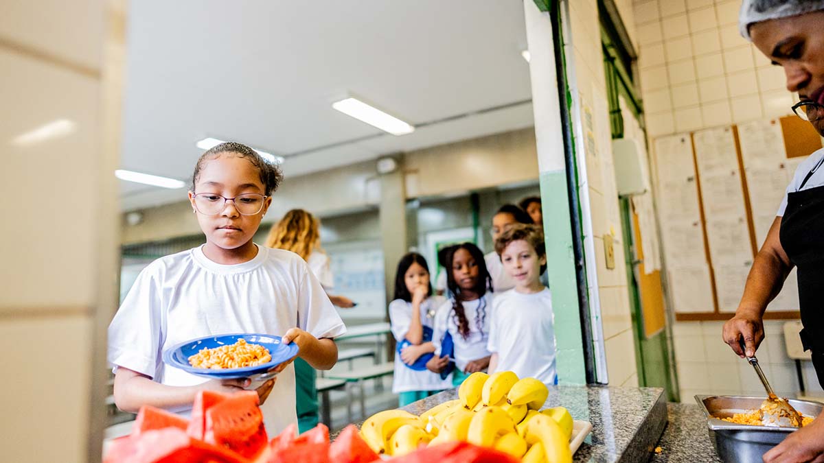 Child Nutrition Reauthorization | Schoolgirl serving themselves during lunch in the school cafeteria