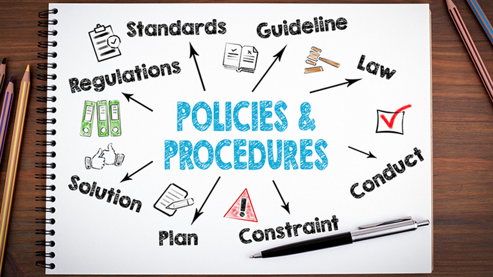 Notebook with the words "policies and procedures" on it