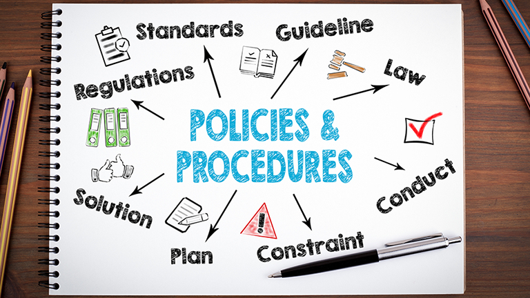 Notebook with the words "policies and procedures" on it