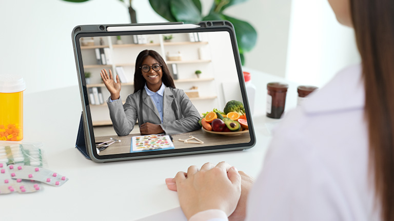 Dietitian waving to client on mobile tablet