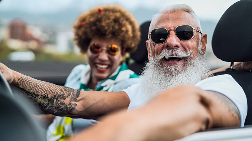 Older couple driving and enjoying retirement