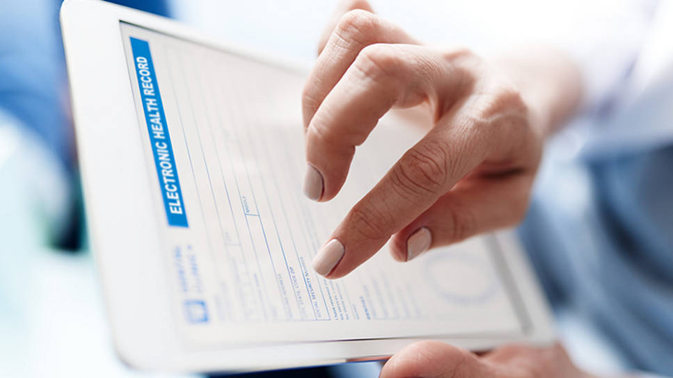 hands entering data into an electrionic health record on a tablet