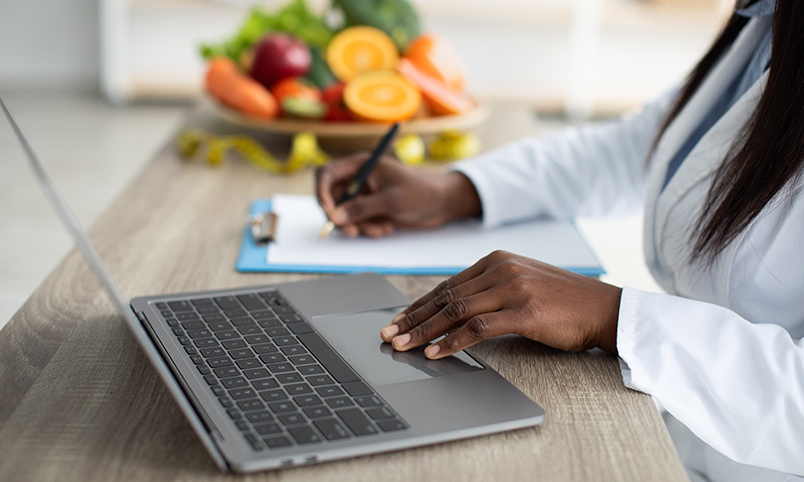 Dietitian calculating nutrition needs of patient or client