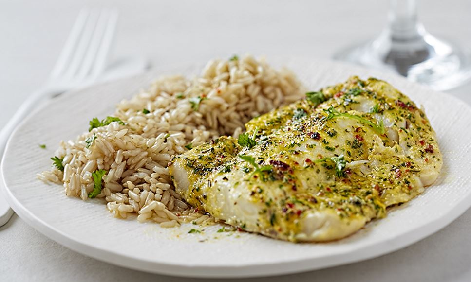 Plate of rice and cod fish represent an article detailing foods with arsenic and ways a registered dietitian nutritionist can help at-risk populations find safe food options.