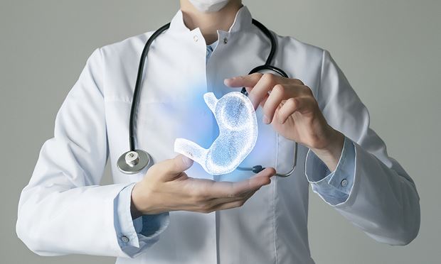 Medical health care professional holding a diagram of the stomach to represent endoscopic bariatric therapies that can be performed for people with obesity.