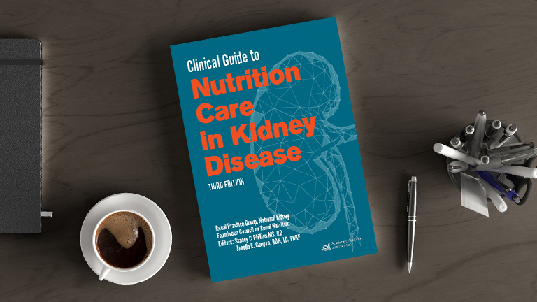 A health care professional's desk with a copy of Clinical Guide to Nutrition Care in Kidney Disease, 3rd Ed.
