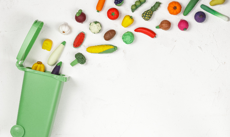Garbage bin with wasted foods artfully displayed for the upcoming Fuel for the Future webinar during National Nutrition Month