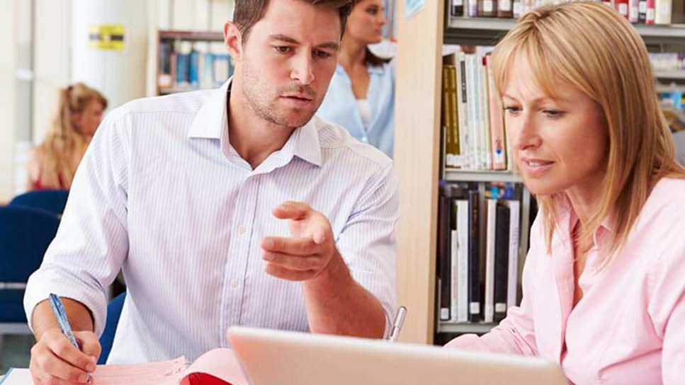 two people working together at a computer